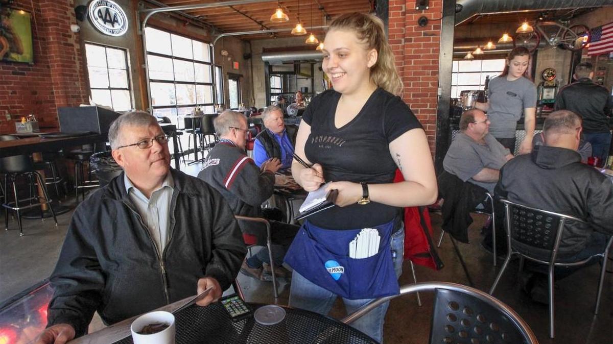 Waitress Savannah Sylvie, center, takes lunch orders at the Pumphouse on Wednesday. Area bars are expecting big crowds on Friday. (March 15, 2017)