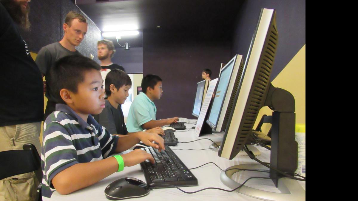 
Khang Tran, Brian Kiralyfalvi and Minh Tran try out Linux games Saturday at Exploration Place. The computers were run by WuLUG, the Wichita State University Linux Users Group, which is trying to spur interest in the free computer operating system.
