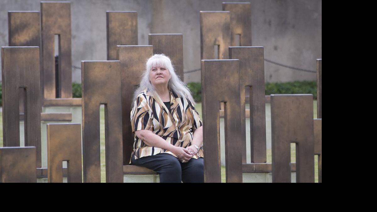 Tina Tomlin sits in a chair that memorializes her husband, Rick, at the Oklahoma City National Memorial.