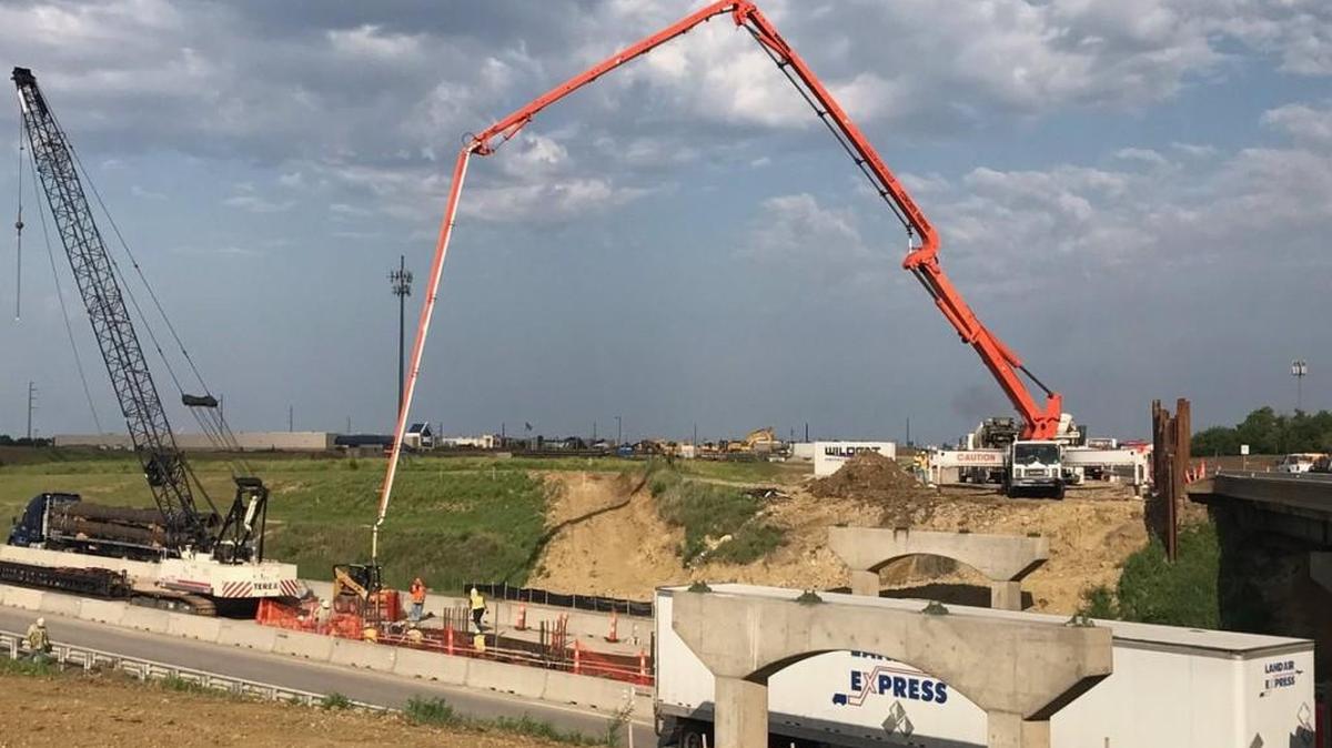 Concrete is pumped for the center pier of the new eastbound Kellogg bridge crossing over the Kansas Turnpike.
