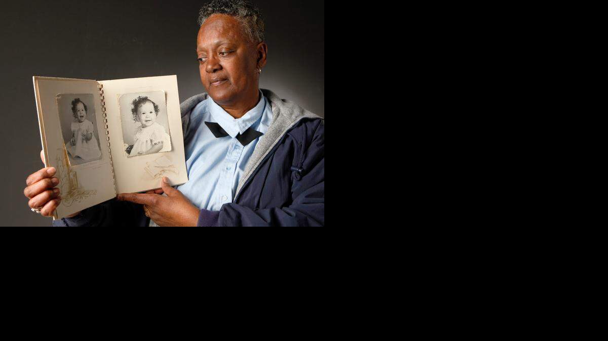 
Sharon Dale-Watkins looks at photos of her little sister Cheryl Dale, who was killed in the 1965 crash of an Air Force tanker in northeast Wichita. Dale-Watkins was 15 at the time of the crash, and she lost her mother, Alice Dale, and 2-year-old Cheryl in the crash. (Jan. 13, 2015)
