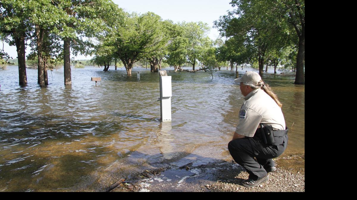 
Kimberly Jones checks out flooded campgrounds at Fall River State Park. Fall River Reservoir was nearly 30 feet above normal at peak flooding this year. On Monday it was still 25 1/2 feet above normal.
