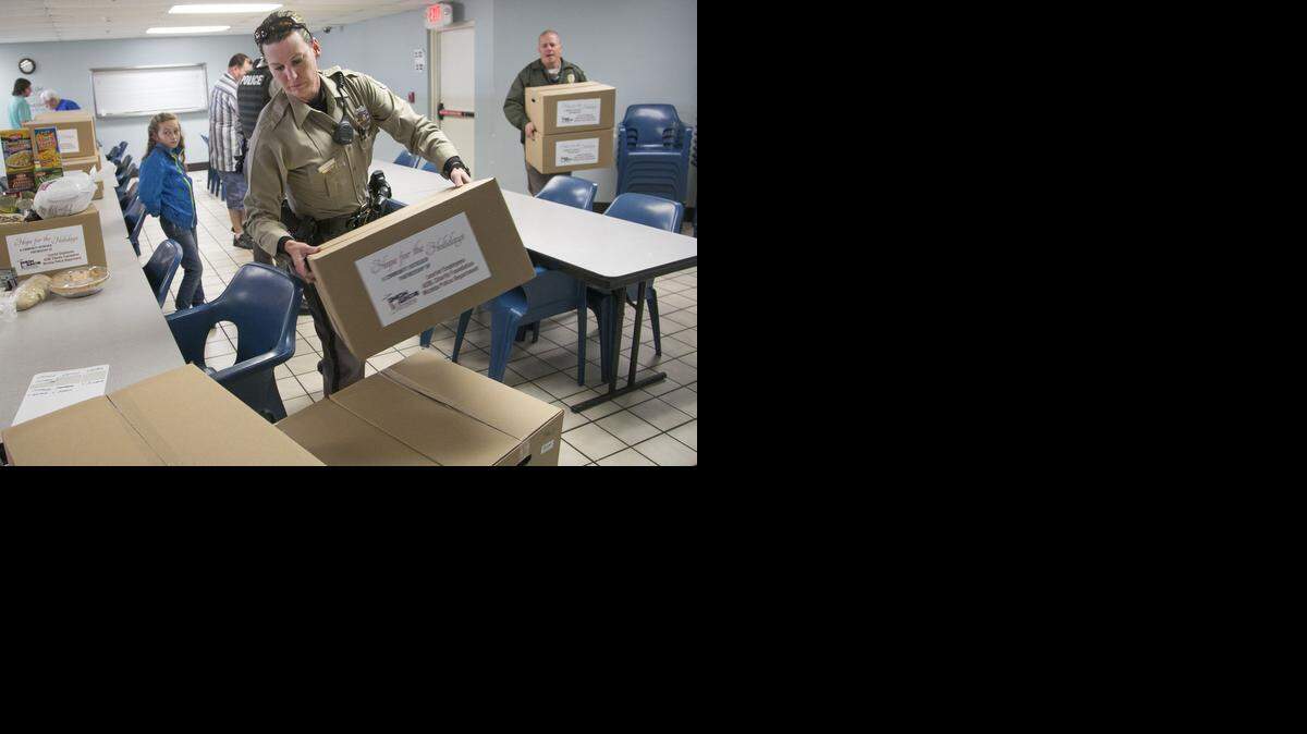 
Wichita police officer Vanessa Rusco loads food boxes for families in need Monday at the Union Rescue Mission. (Nov. 24, 2014) 
