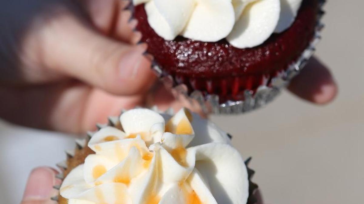 An apple filled cupcake and velvet with cream cheese from Brown Box Bakery.