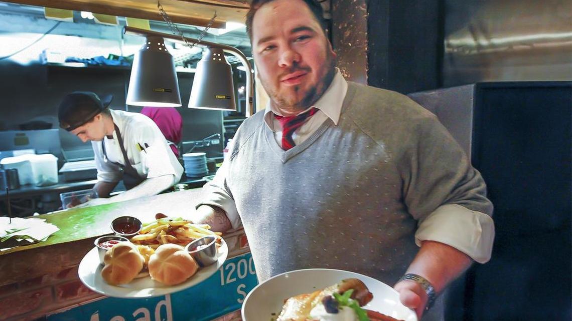Public manager Mikel Bowyer serves some food to his customers Wednesday night. Public likes to use locally sourced food. Bowyer would like to start a public market behind Union Station. (Dec. 23, 2015)