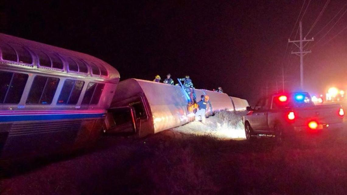 Emergency personnel work on a train that derailed near Dodge City on March 14. The train was traveling from Los Angeles to Chicago early Monday when it derailed just after midnight.