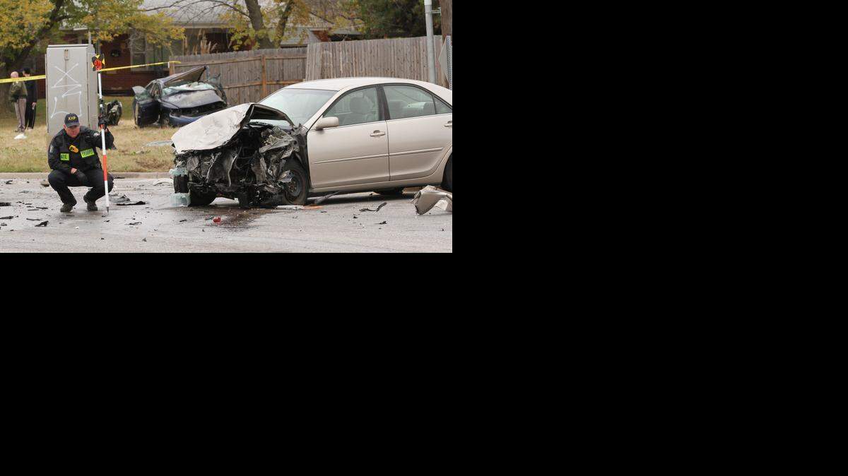 
A Kansas Highway Patrol investigator looks at the scene of a two-car collision at the corner of George Washington Boulevard and Pawnee that happened Tuesday morning. A man and child were in the car next to the trooper and the car in the background was a car police were pursuing at the time of the crash, a sheriff official said. (Nov. 4, 2014)
