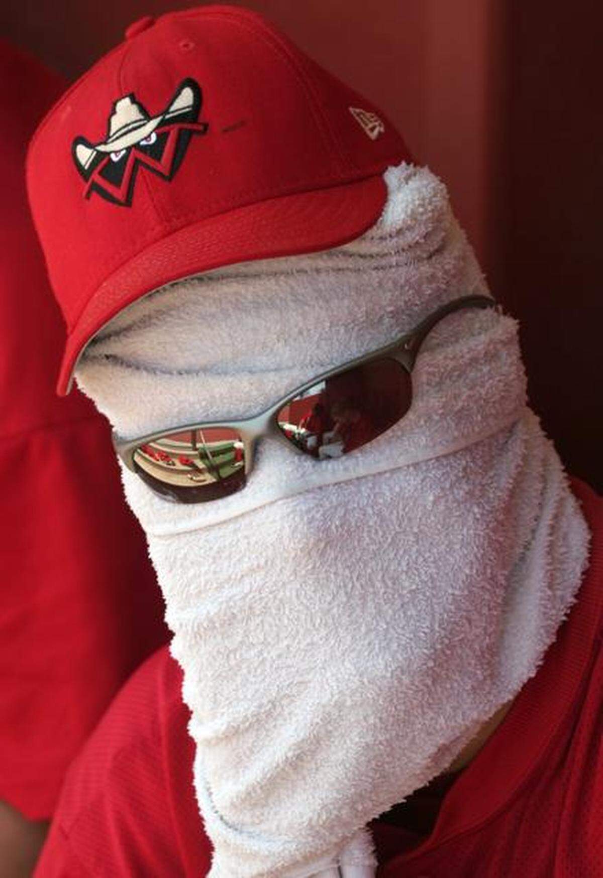 FILE Wrangler third basemen Alex Gordon wraps his head in a wet towel during a hot afternoon game against Springfield in 2006.