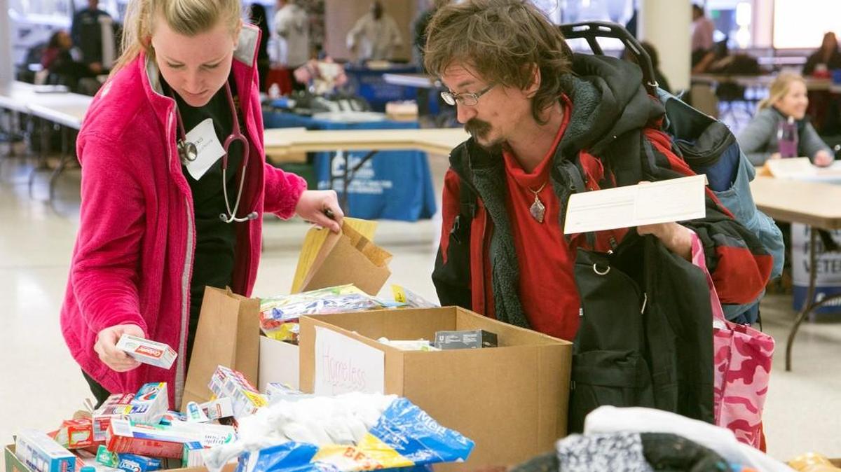Alexis Bateman, a student in accelerated nursing at Wichita State University, helps Billy Goering select toiletries during a homeless count in January for the Sedgwick County area. (Jan. 28, 2016)