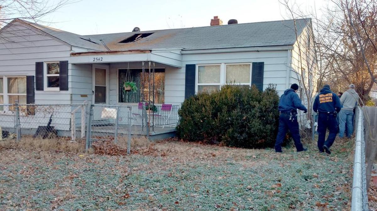 Wichita Fire Department investigators look over the scene of an overnight fire that started in an attic furnace at 2542 S. Ellis early Wednesday morning. (Jan. 13, 2016)