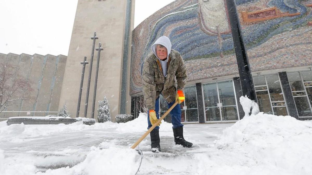 Marvin Robertson shovels snow outside First United Methodist Church on Broadway in 2014. Students from Wichita State University will sleep in the church parking lot Monday night in an effort to draw attention to the problem of homelessness.