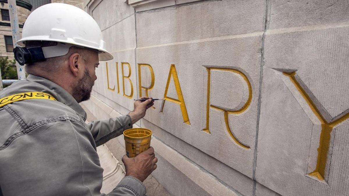 
Robert Elliott, owner of Art Effects, prepares the letters above the entrance of the historic Wichita Carnegie Library for gold leaf. (May 13, 2015)
