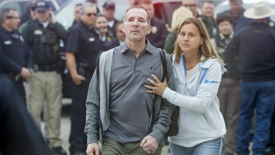 Officer Brian Arterburn, left, and his wife, Claudale, get ready to greet officers who came out to welcome him home after he returned to Wichita on Nov. 29, 2017, following months of treatment for injuries he received when he was run over last year.