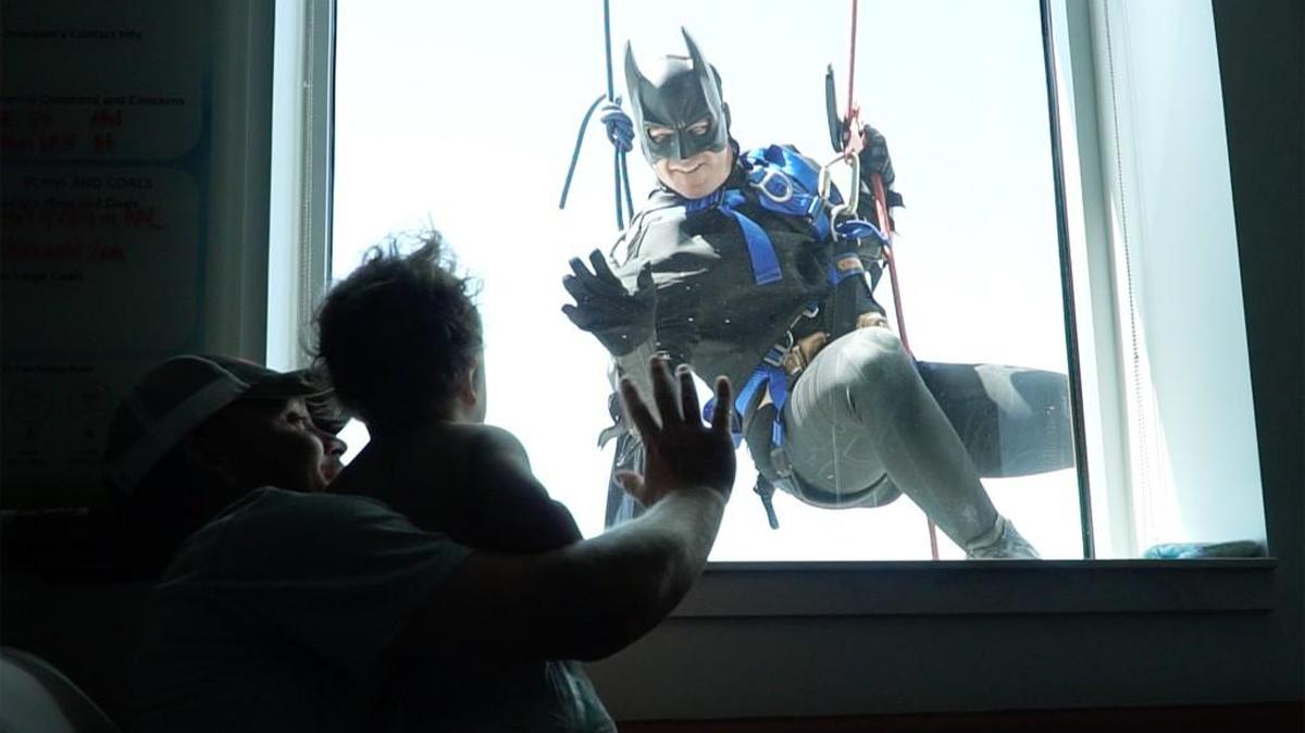 Clay Shelton and his 20-month-old son, Tito, wave to a Wichita Police Department SWAT Team member dressed as Batman. Six members of the SWAT team dressed as superheroes and rappeled down the Wesley Children’s Hospital building during its grand opening. Eagle photojournalist Jaime Green received a Heart of America award for the photo from the Kansas City Press Club. (Sept. 1, 2016)