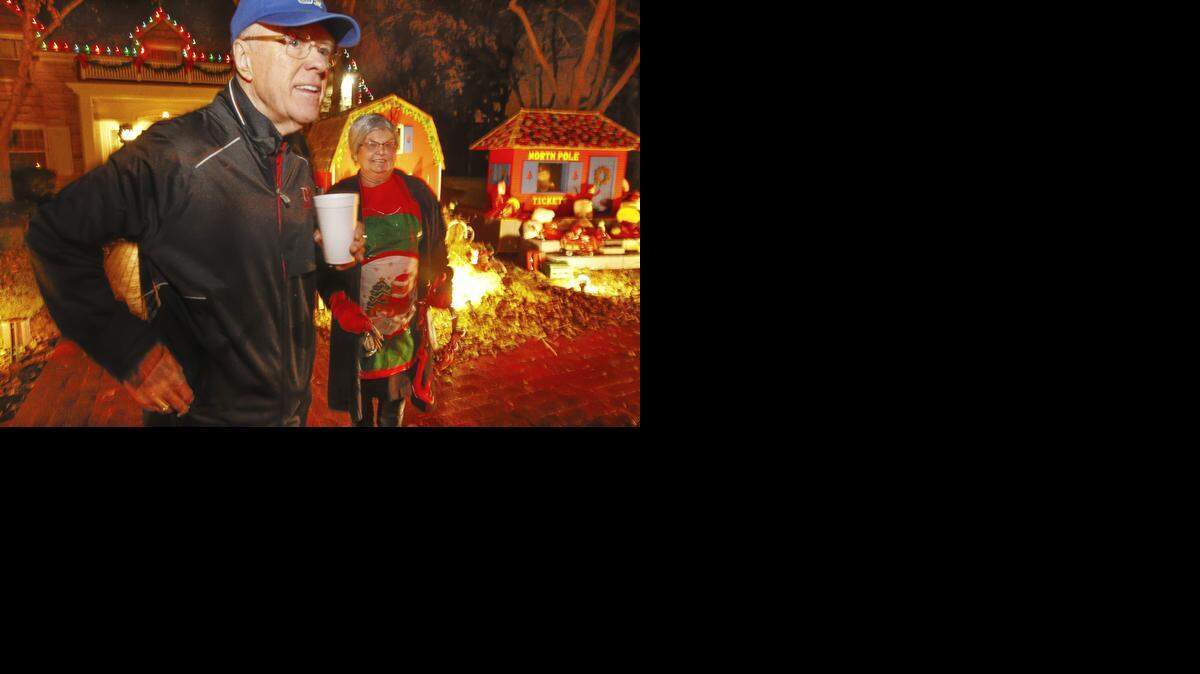 
Former Koch executive Bill Hanna and Mrs. Claus wait to greet visitors to Hanna's home, where a Christmas Lights display was set up to take donations for the Wichita Children's Home Friday night. Hanna has been doing this for 25 years and thinks this will be the last year he can do it. (Dec. 12, 2014)
