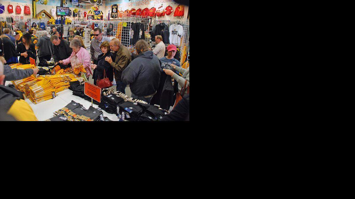 
Customers pick over new Wichita State shirts at Tad’s Locker Room in east Wichita on Monday morning. (March 23, 2015)
