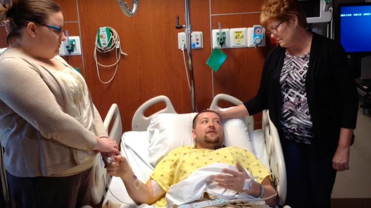 Adam Miller, with wife, Nickie, left, and mother, Linda, discusses Thursday’s shooting in Hesston from his hospital bed. Miller was shot four times. (Feb. 26, 2016)