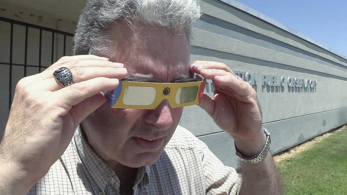 Harold Henderson of the Lake Afton Observatory dons a pair of glasses that can be used for viewing the upcoming solar eclipse in August. A full solar eclipse will pass over the central United States on August 21. In Kansas, the best place to see the eclipse with be in the northeast corner of the state, though the sun will be about 93 percent covered in Wichita.