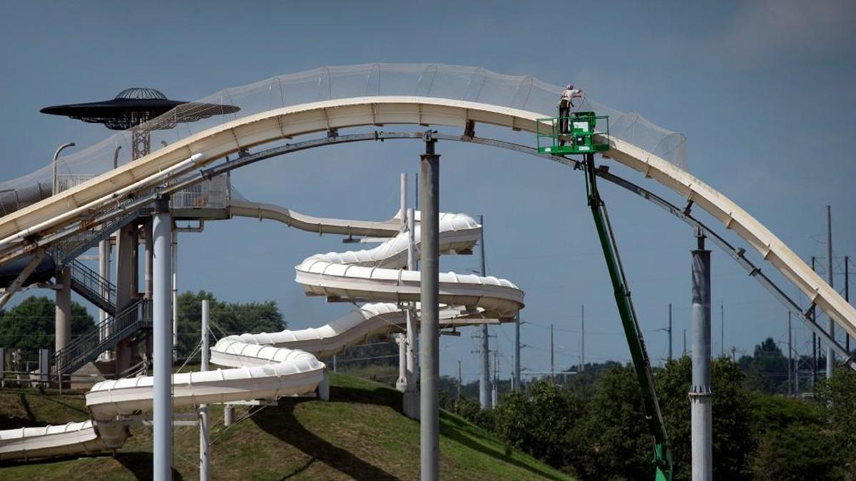 A worker takes down netting from the Varruckt waterslide Tuesday at the Schlitterbahn Waterpark in Kansas City, Kan.