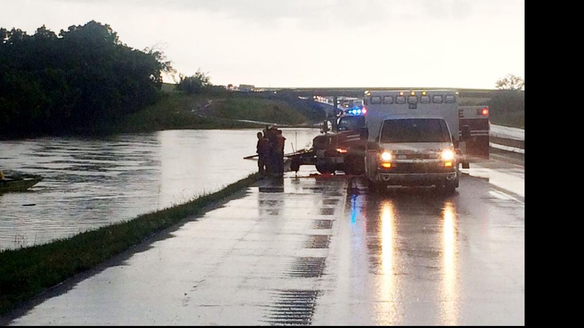 
Rescue workers watch as rescue boats look for the body of Zachary Clark, whose car went off the road during a heavy thunderstorm July 10 on the Kansas Turnpike south of Emporia.
