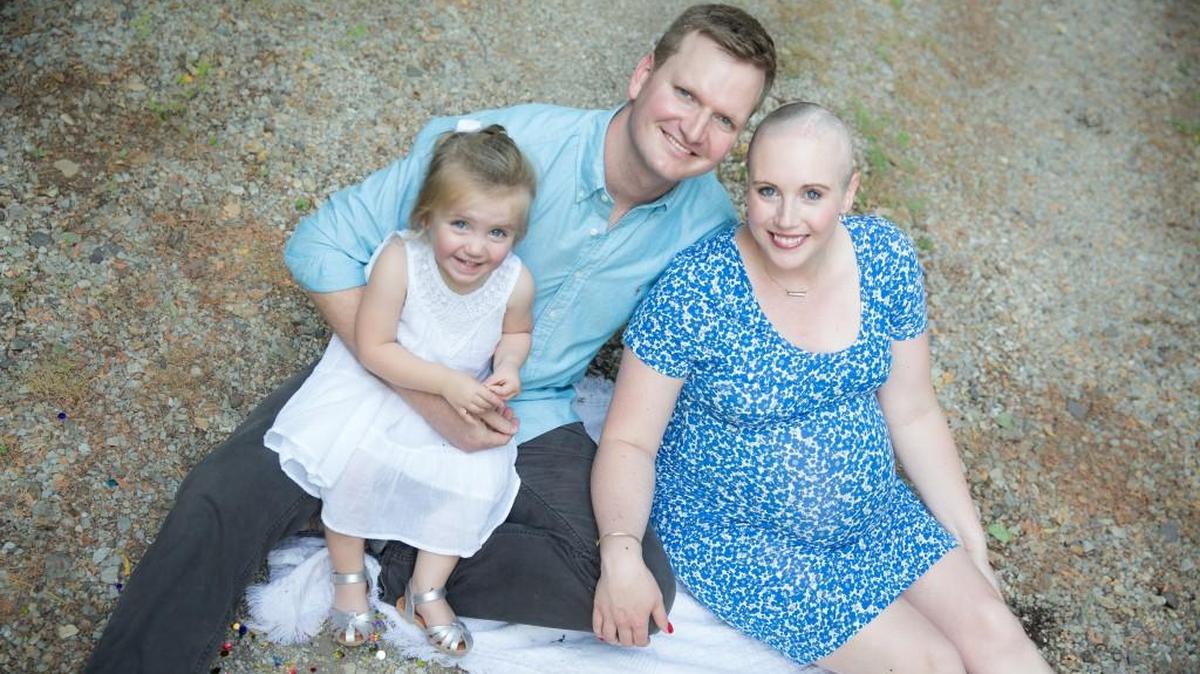 Danielle Dick with her husband, Tyler Dick, and their 2-year-old daughter, Taylor. Danielle, 31, is pregnant with twins and fighting stage four melanoma.