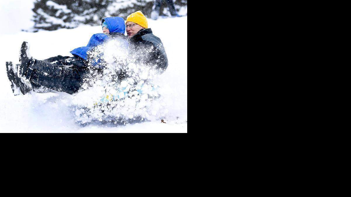 
Doug Shaffer, right, and his son Ben, 8, hit a bump Saturday while sledding at the Mid-America All-Indian Center. (Feb. 28, 2015) 
