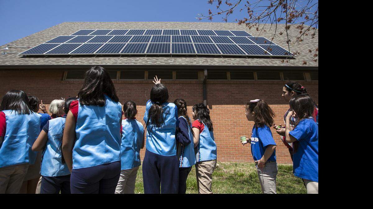 
Students in Cloud Elementary’s Earth Day Ensemble look at the solar panels on the roof of University United Methodist Church. The panels were dedicated Wednesday. (April 22, 2015)
