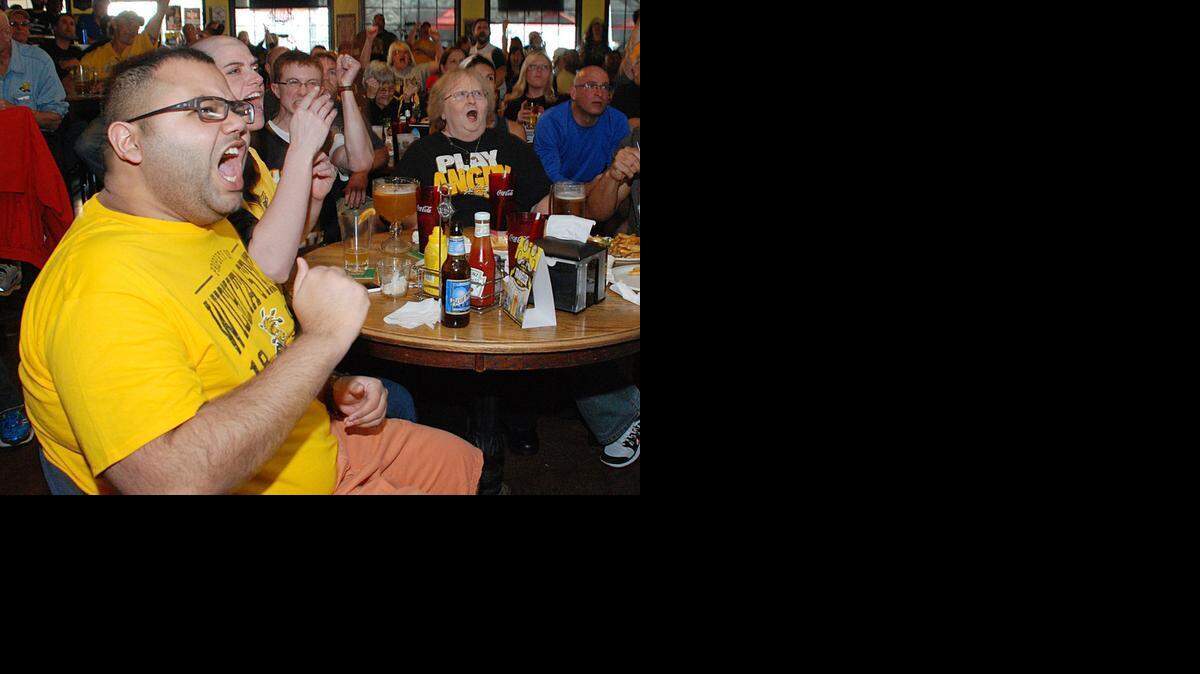 
Shocker fan M.J. Attawaca cheers while watching the Wichita State vs. Kansas game Sunday at Larry Bud’s Sports Bar and Grill at 21st and Woodlawn.

