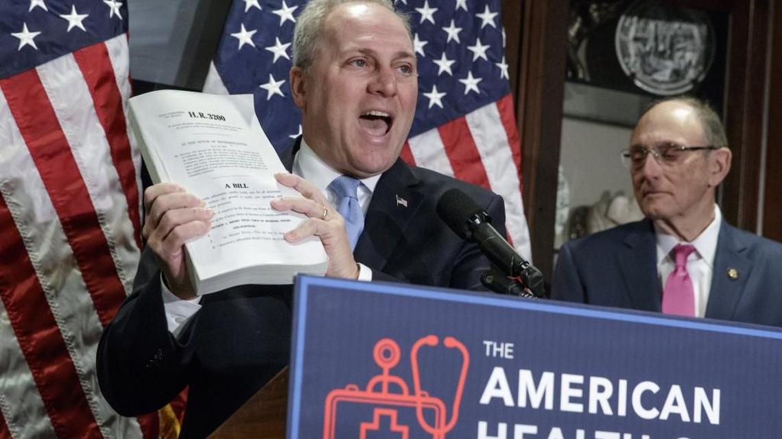 House Majority Whip Steve Scalise of La., left, joined by Rep. Phil Roe, R-Tenn., holds up a copy of the original Affordable Care Act bill during a news conference in Washington on Wednesday, as the GOP leadership talks about its work on the long-awaited Republican plan to repeal and replace “Obamacare.”