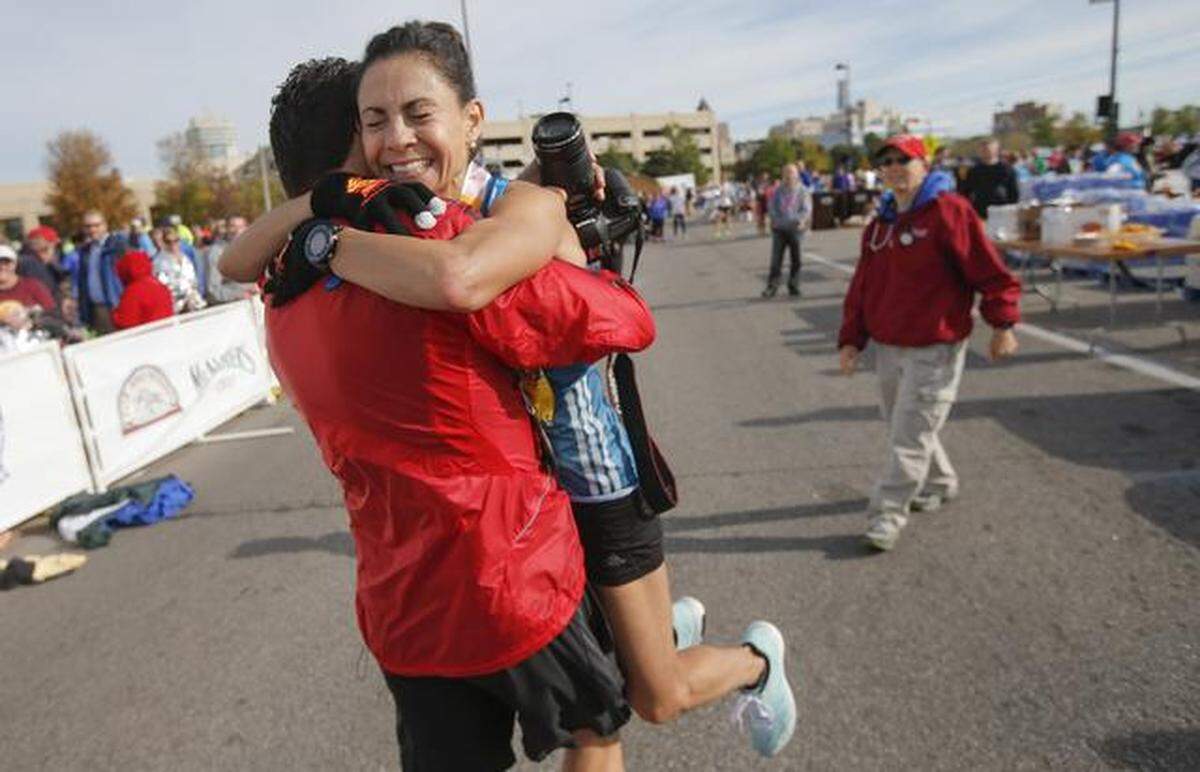 Raquel Rios-Ree of Pretty Prairie is hugged by her brother, Hector Rios, after she broke the Kansas state record in the marathon in 2014. She had an unofficial time of 2:44:56 to lead all women in the Prairie Fire Marathon.
