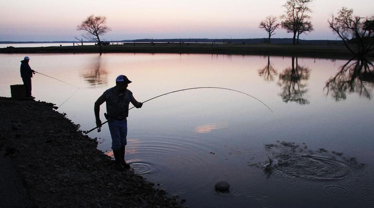 People fish for crappie at Elk City State Park. Coves in the state park provide good crappie fishing most springs.