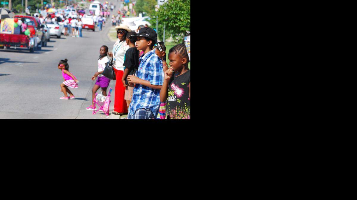 
A child looks for candy as she watches the Black Arts Festival parade Saturday morning.
