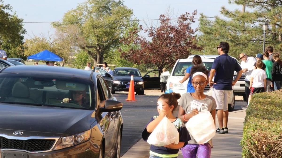 
Volunteers bring out to-go meals to people in the St. George Orthodox Christian Cathedral parking lot on Saturday.
