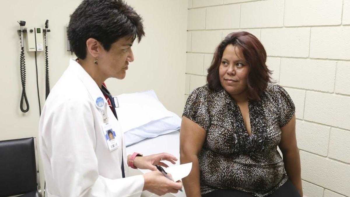 Physician Sheryl Beard talks with Lorenza Martinez about her medication at Guadalupe Clinic on Monday. On faculty at the family medicine residency program at Via Christi, Beard volunteers one half-day per month at the clinic. (July 10, 2017)