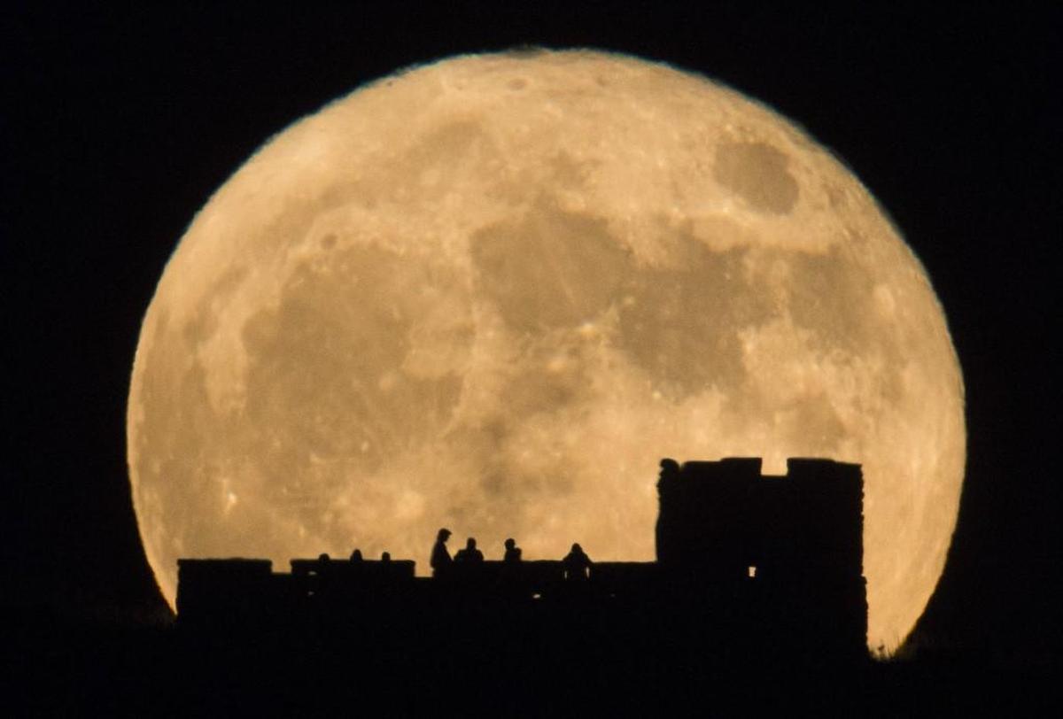 People watch as the supermoon rises over Coronado Heights near Lindsborg in 2016.