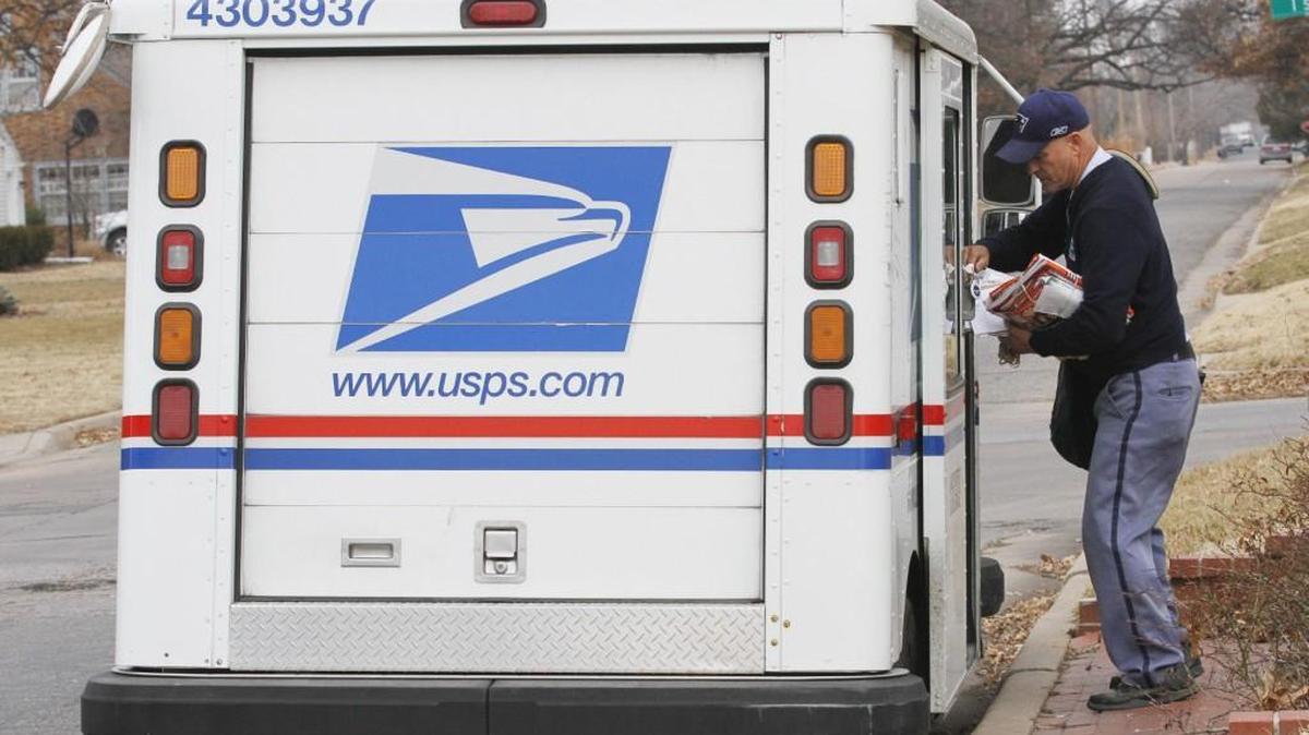 A letter carrier for the U.S. Postal Service gets ready to deliver mail in east Wichita in this 2013 file photo.