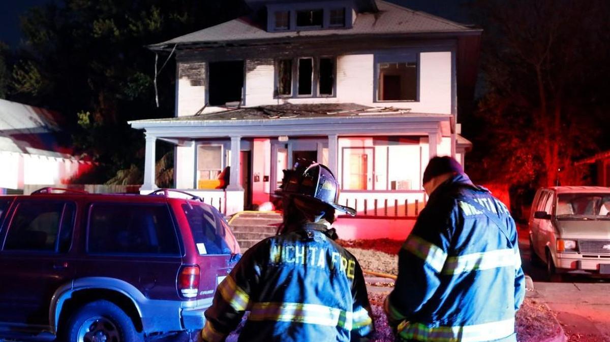 
Wichita firefighters consult following an early morning fire at 1343 S. Water on Nov. 12, 2014.
