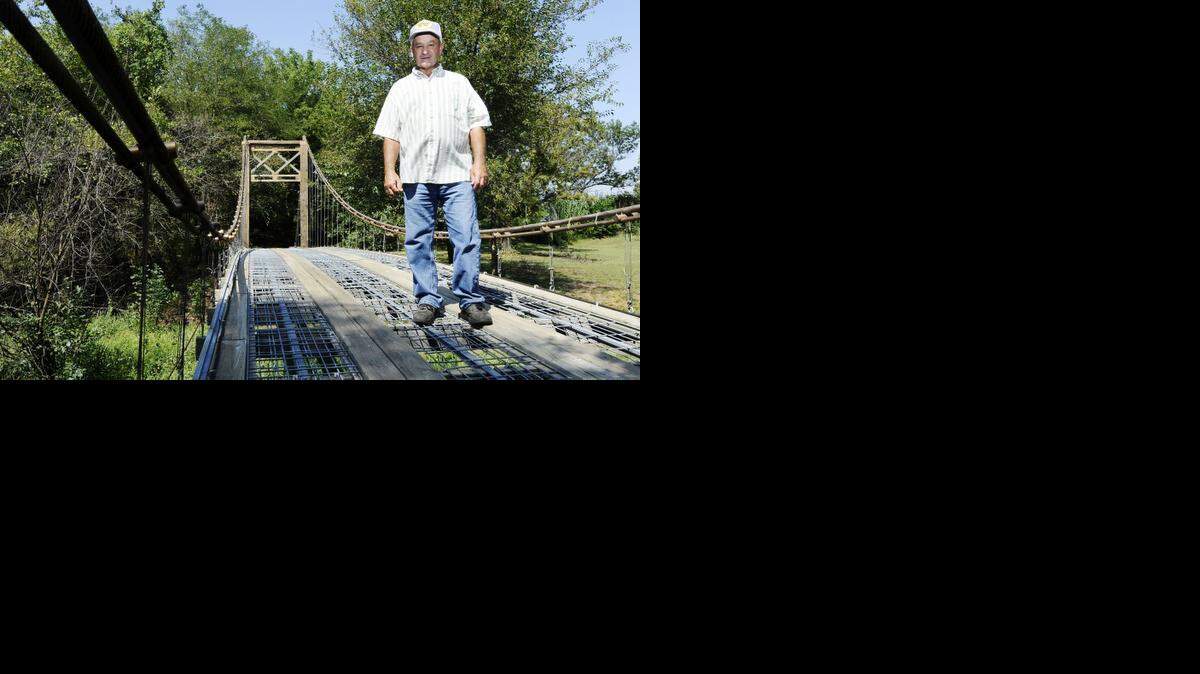 
Larry Richardson, a retired postman, on the 150-foot model of the Golden Gate Bridge that he built over a creek on his property in Mulvane, Kan., Sept. 15, 2010. Richardson connected his property to an undevelopable sliver of weed-choked wasteland using salvaged materials, family labor and nearly $5,000 of his own money. 
