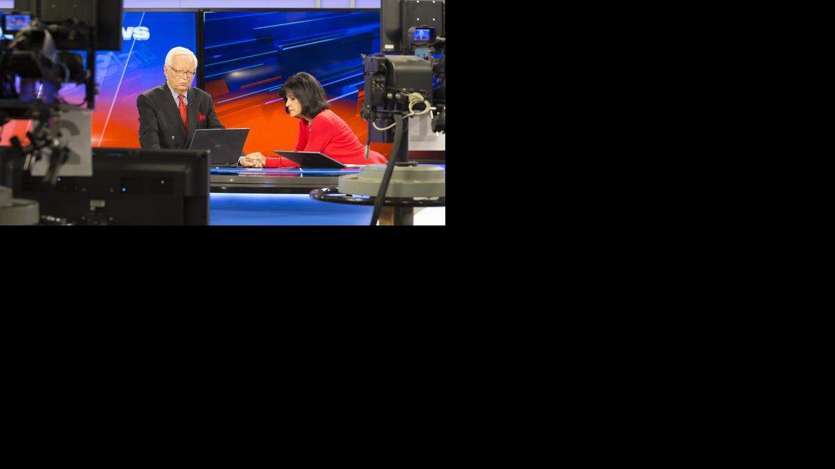 
Larry Hatteberg and co-anchor Susan Peters wait for their final segment to being during the 10 p.m. broadcast in the KAKE Television studio on Tuesday. Hatteberg anchored his final show after working at KAKE for 51 years.
