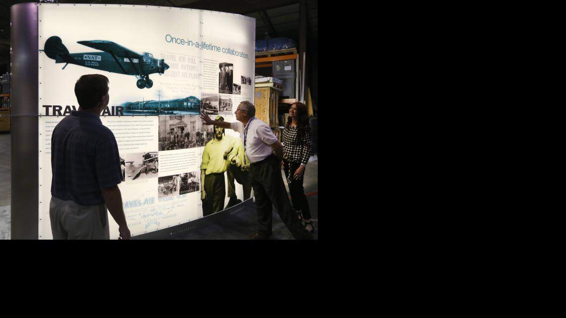 
Victor White, director of airports for the City of Wichita, touches a prototype of a display highlighting Wichita's aviation history. This is one of six displays being built at Image Resources that will be at the new airport terminal when it opens. At far right is Sonia Greteman of the Greteman Group, the branding agency that designed the display. (August 28, 2014)
