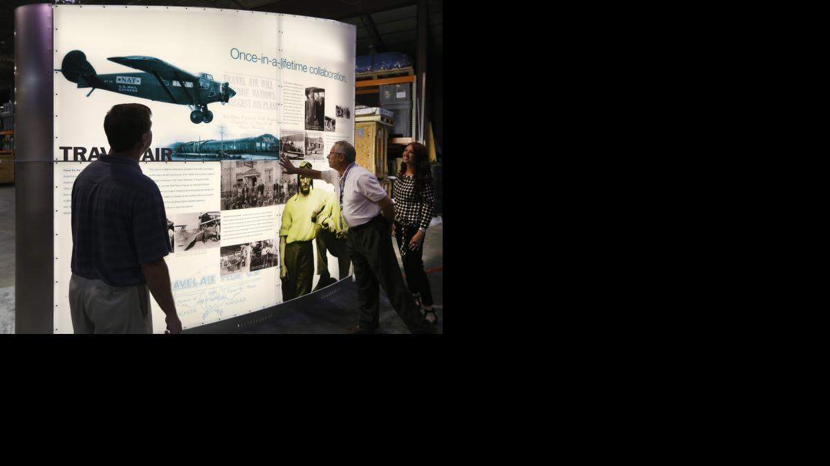 
Victor White, director of airports for the City of Wichita, touches a prototype of a display highlighting Wichita's aviation history. This is one of six displays being built at Image Resources that will be at the new airport terminal when it opens. At far right is Sonia Greteman of the Greteman Group, the branding agency that designed the display. (August 28, 2014)
