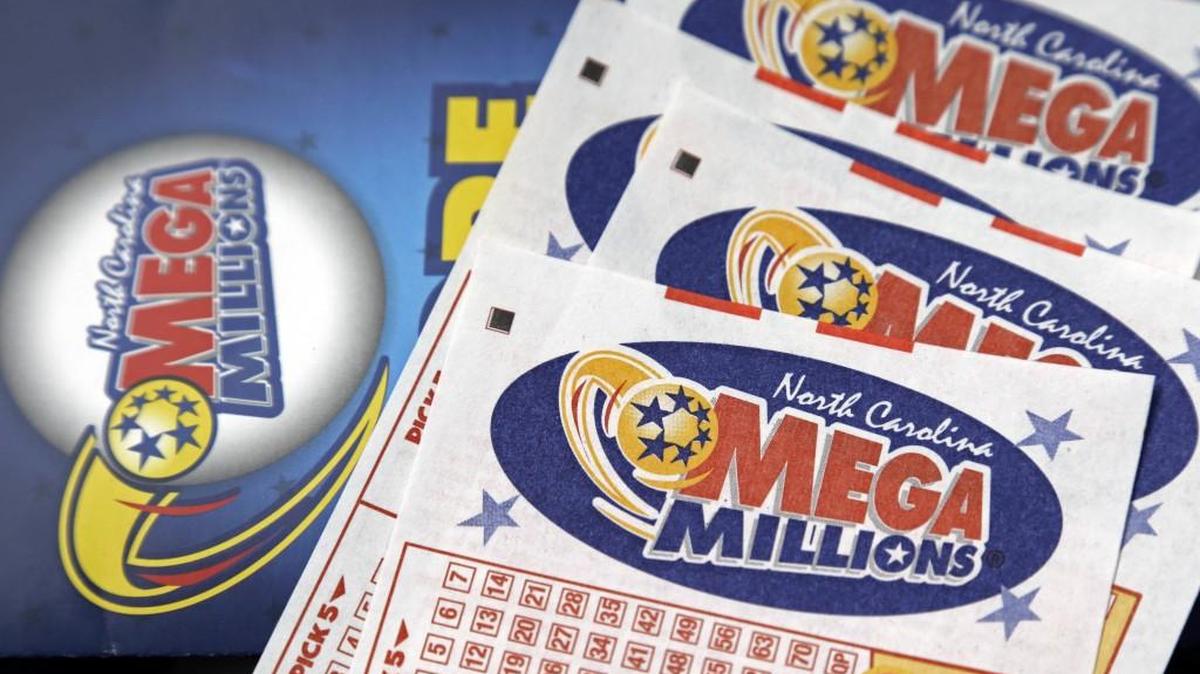 Mega Millions lottery tickets rest on a counter Friday.