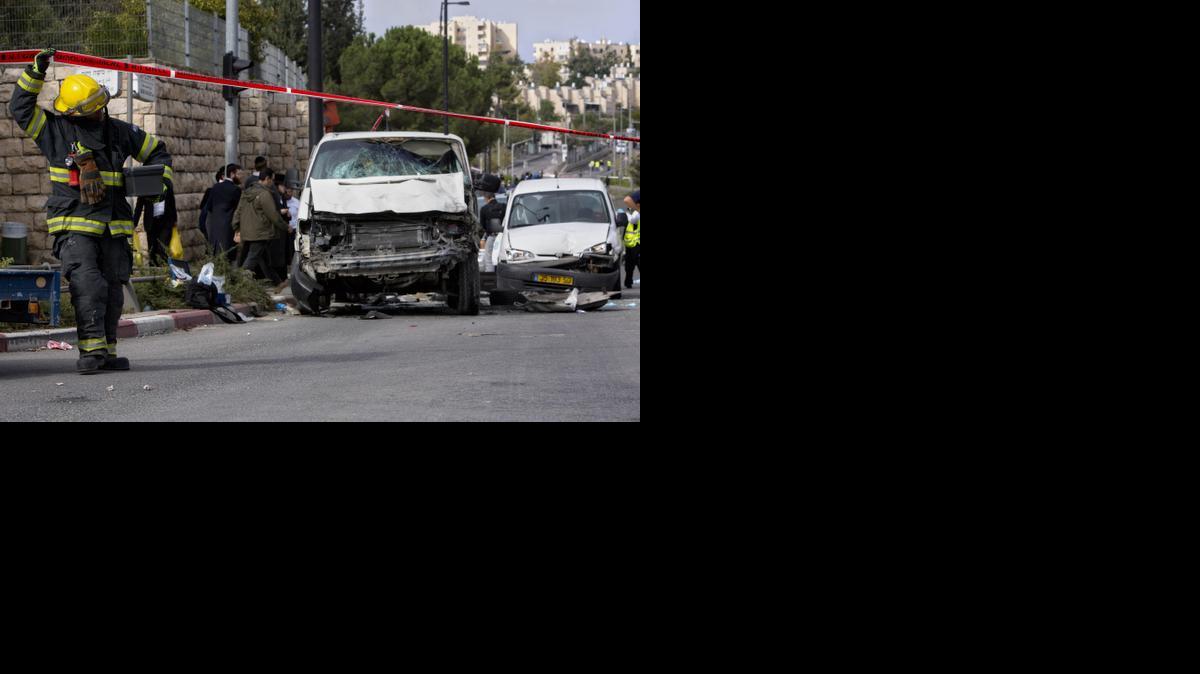 
An Israeli firefighter walks at the scene of an attack in Jerusalem, Wednesday. A Palestinian man rammed his van into a crowded train platform in east Jerusalem and then attacked people with an iron bar.

