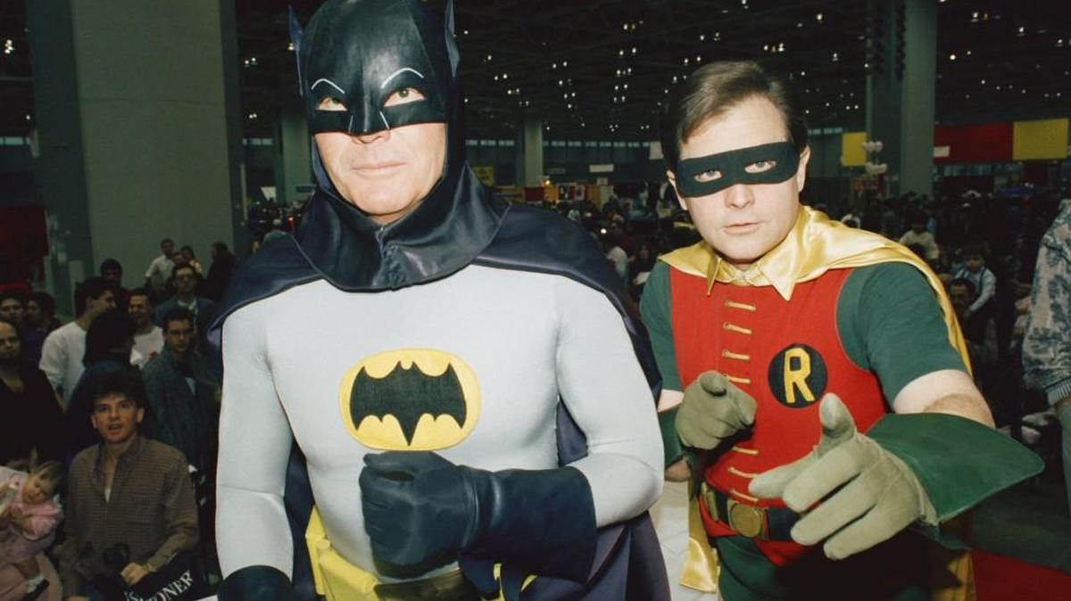 Actors Adam West, left, and Burt Ward, dressed as their characters Batman and Robin, pose for a photo in 1989. West died June 9 at age 88.