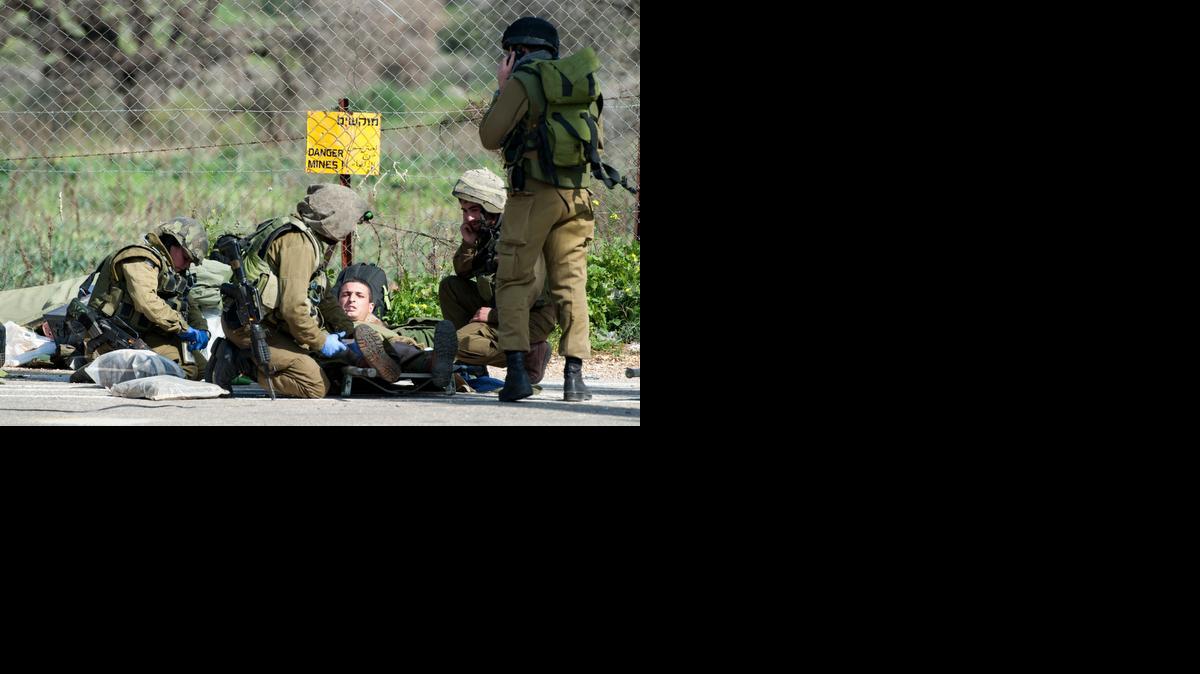 
Israeli soldiers treat a wounded soldier near the Israel-Lebanon border, Wednesday. A missile fired by the Lebanese Hezbollah group struck an Israeli military convoy on Wednesday, killing two soldiers in an apparent retaliation for a deadly airstrike that killed many Hezbollah fighters in Syria earlier this month.
