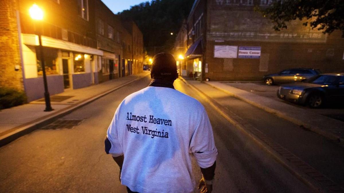Garnet Edwards Jr. walks along a street in the business district in Welch, W.Va., on Oct. 5 while volunteering for a nonprofit community organization. “There’s no place like home. We’re always going to be here,” said Edwards, a native of Welch. “All it takes is one person to keep caring.”