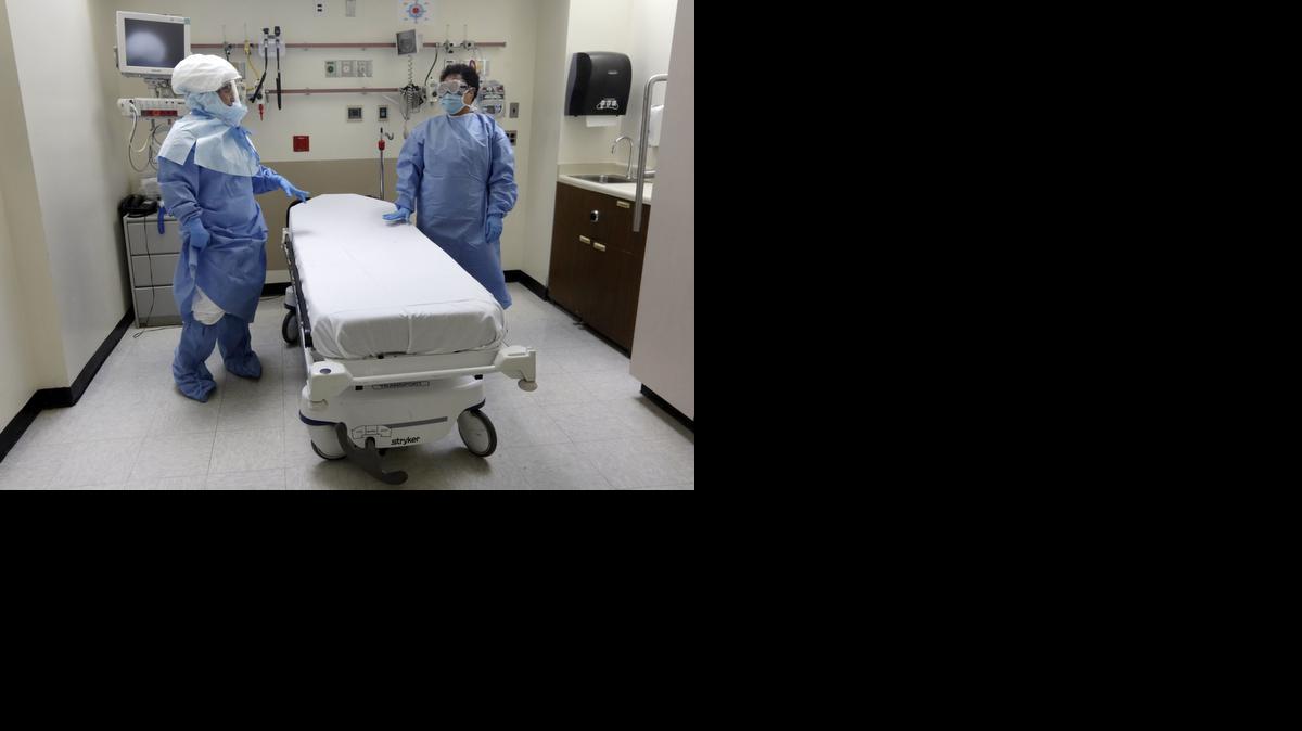 
Bellevue Hospital nurse Belkys Fortune, left, and Teressa Celia, Associate Director of Infection Prevention and Control, pose in protective suits in an isolation room, in the Emergency Room of the hospital, during a demonstration of procedures for possible Ebola patients in New York. 
