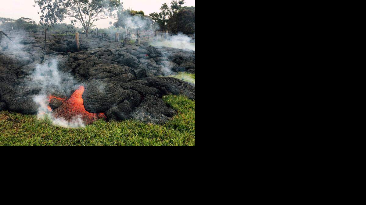 
This Oct. 26, 2014, photo provided by the U.S. Geological Survey shows the lava flow front of from an eruption that began June 27, as the front remains active and continues to advance towards the northeast threatening the town of Pahoa on the Big Island of Hawaii. Dozens of residents in this rural area of Hawaii were placed on alert as flowing lava continued to advance. 
