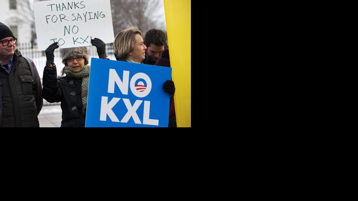 
Yvette Torell, left, with 350.org, holds up a sign that says "Thank for Saying No to KXL", next to Melinda Pierce, right, of the Sierra Club, as they join other opponents of Keystone XL to celebrate President Obama's veto of the legislation outside the White House on Tuesday.
