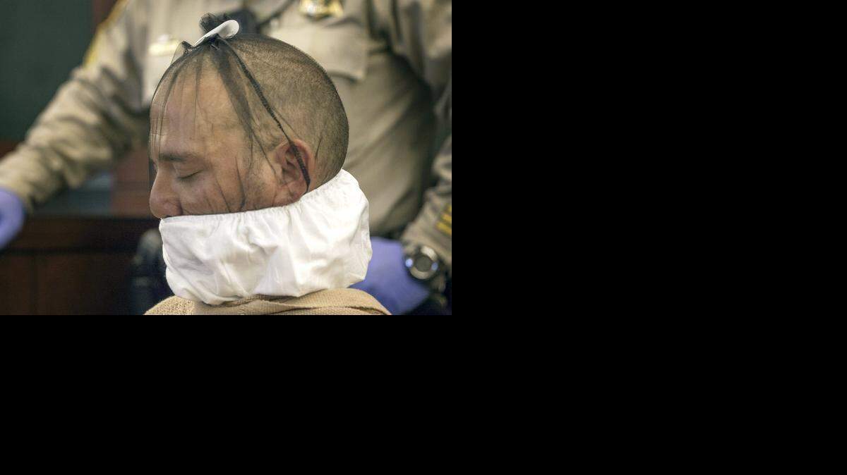 
This July 30, 2014, file photo shows Scott Carmitchel during a court appearance in Las Vegas. Officers placed a spit mask on Carmitchel's face. The district attorney in Las Vegas says Carmitchel, a Kansas felon being held in the gunpoint robberies of a Bellagio casino cashier and a community bank branch will face federal charges that could get him up to 27 years in prison as a career offender.
